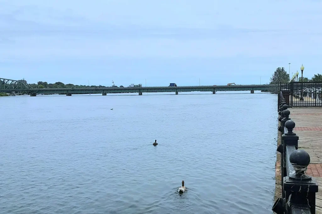 Riverfront boardwalk at Elizabeth Park in Trenton, Michigan, looking south along the Detroit River toward the bridge to Grosse Ile