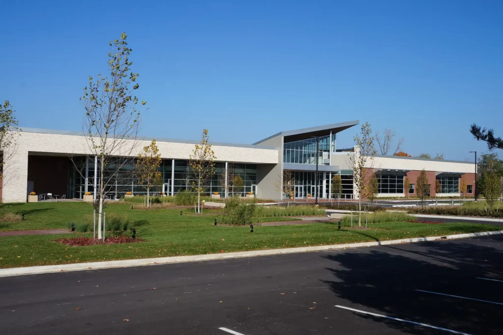 The modern glass, stone and brick Westland City Hall building with new landscaping on a clear autumn day